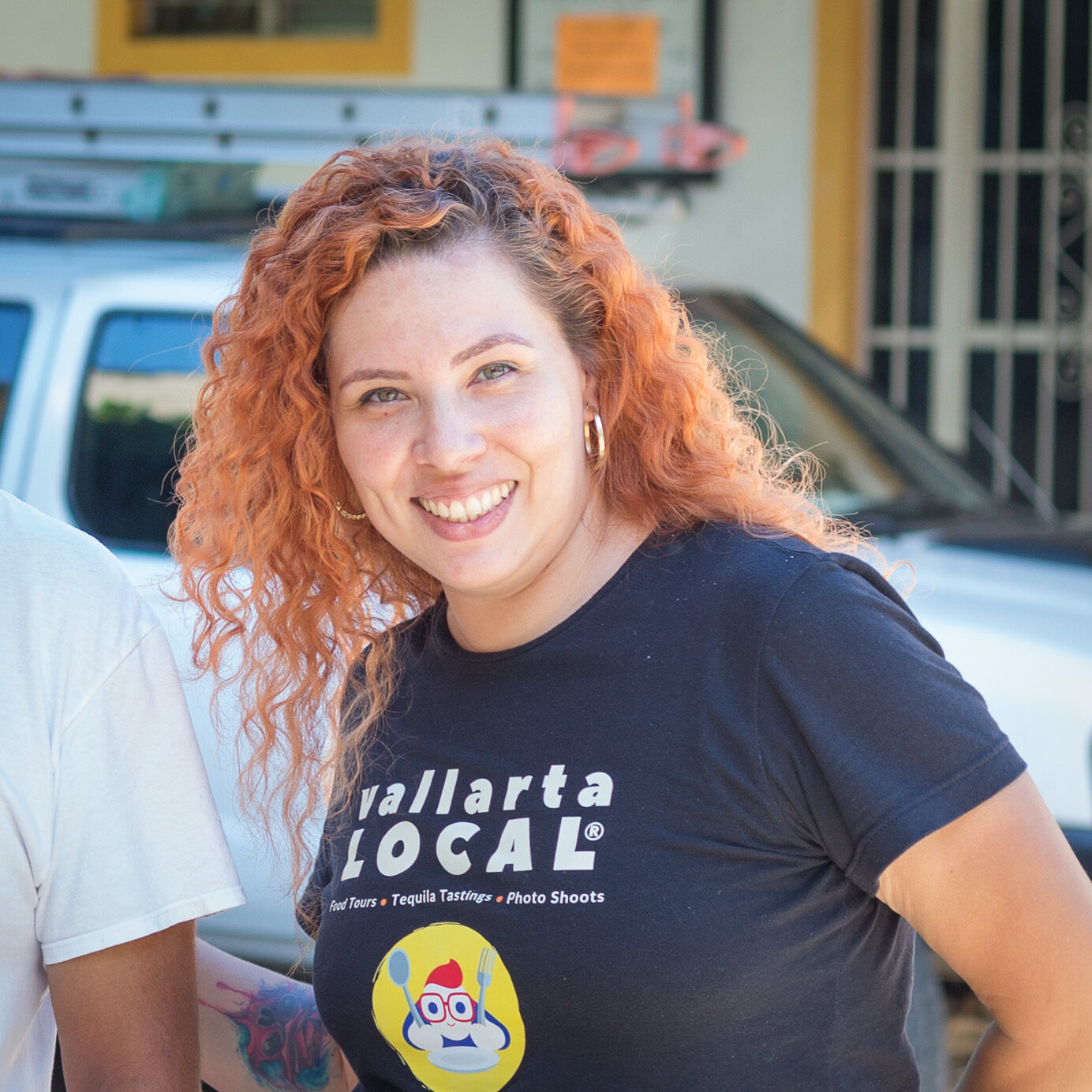 Mexican Woman wearing a black tshirt with the logo of a Food Tour in Puerto Vallarta